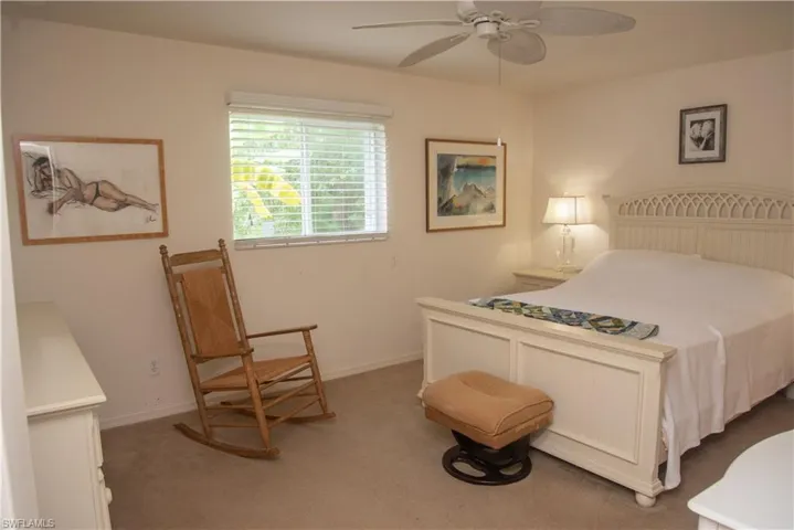 Bedroom with ceiling fan and carpet floors