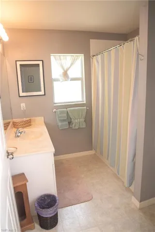 Bathroom with tile patterned floors and vanity