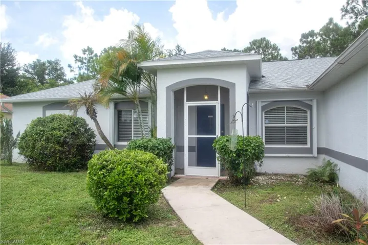 Property entrance featuring a lawn