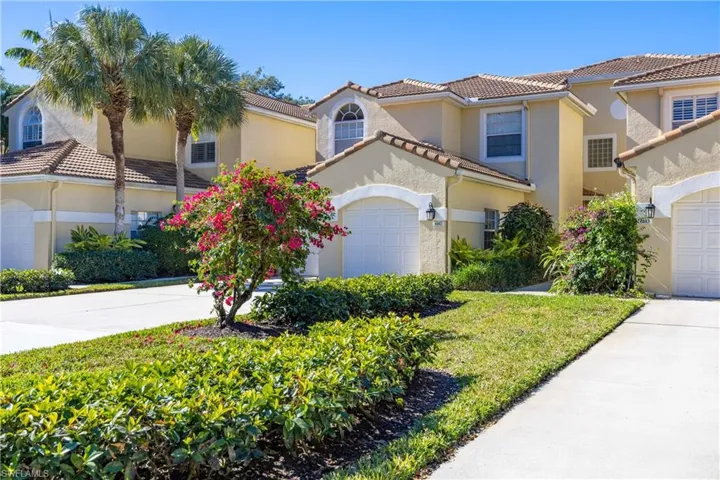 Mediterranean / spanish-style home featuring stucco siding, a tiled roof, concrete driveway, and a front lawn