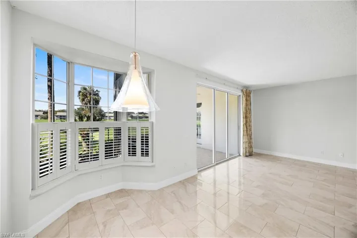 Unfurnished dining area featuring baseboards and a textured ceiling
