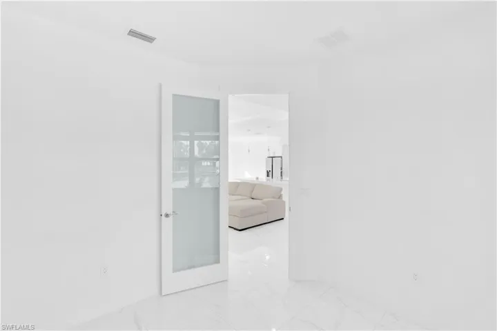 Spare room featuring light marble finish flooring