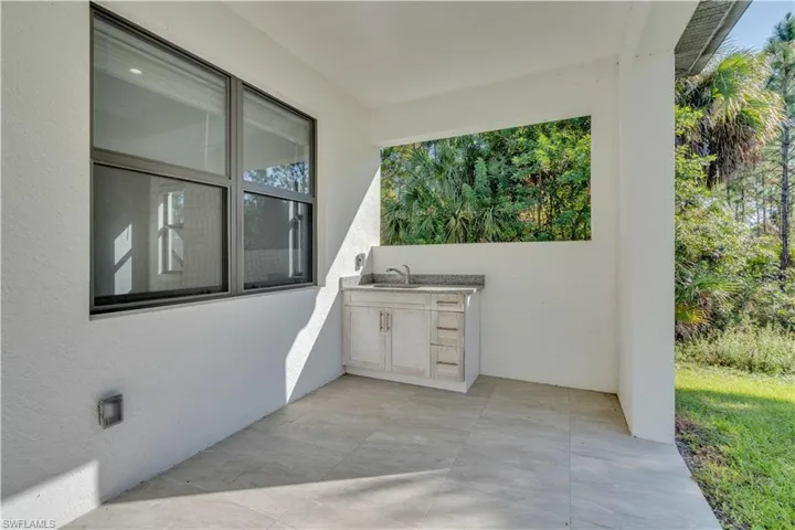 View of patio featuring an outdoor kitchen and a sink