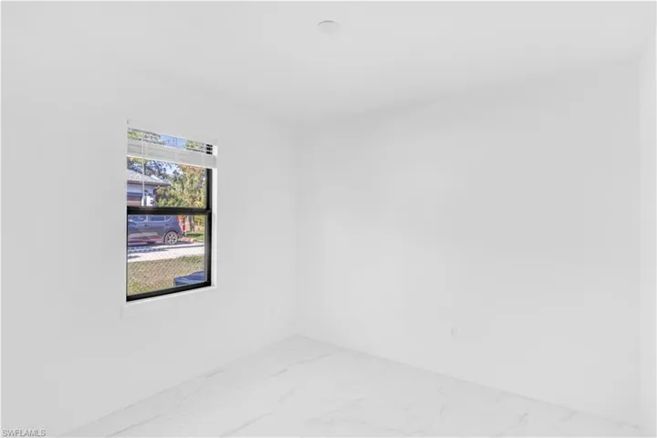 Empty room with light marble finish flooring and baseboards