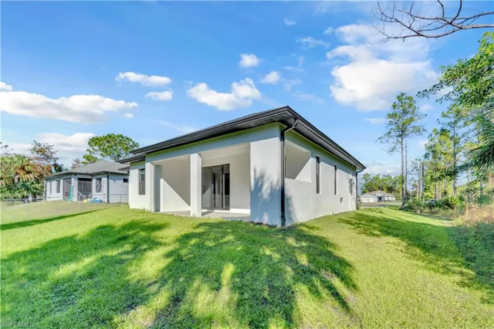 Back of property with a patio area and stucco siding