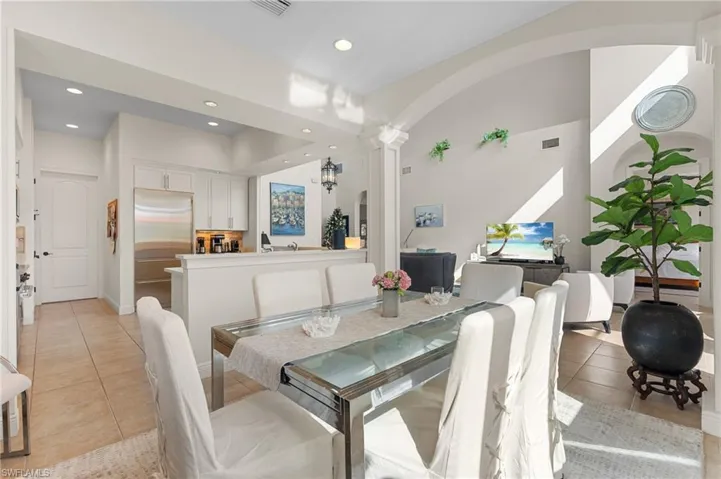 Dining room featuring decorative columns and light tile patterned floors