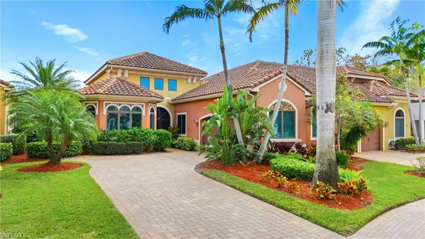 Mediterranean / spanish home with a front lawn and a garage