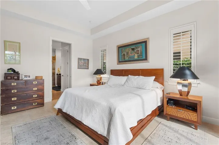 Tiled bedroom featuring ensuite bath