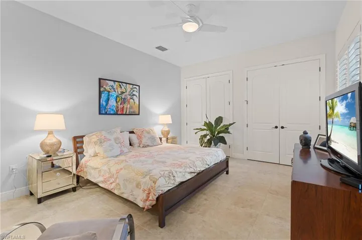 Bedroom featuring multiple closets and ceiling fan