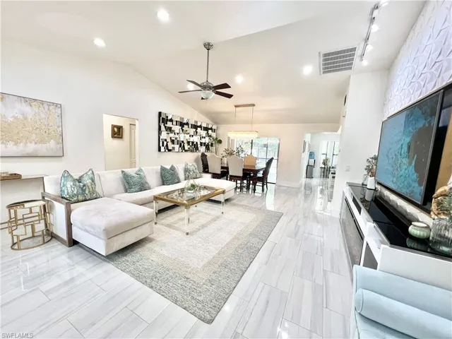 Spacious living area featuring high vaulted ceilings and recessed lighting