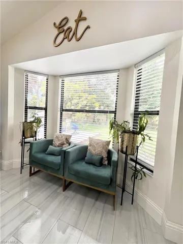 Bay window featuring multiple windows with horizontal blinds