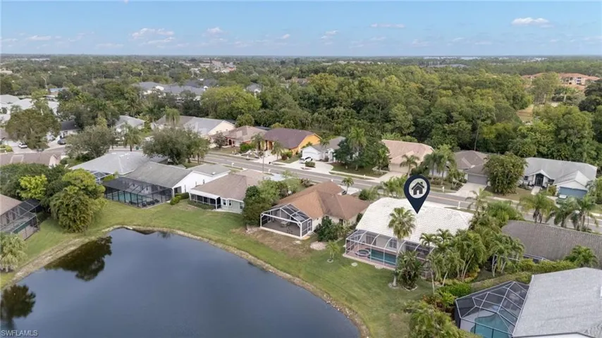 Aerial view of residential area featuring a large body of water