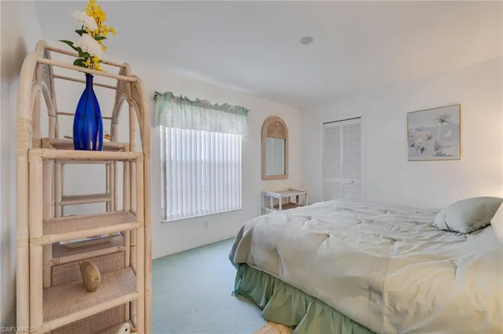 Carpeted bedroom featuring a closet