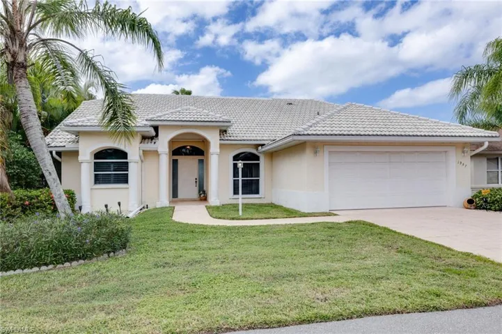 Mediterranean / spanish home featuring stucco siding, a front yard, concrete driveway, a garage, and a tile roof