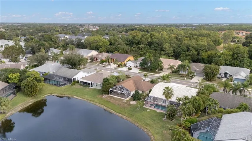 Aerial perspective of suburban area featuring a nearby body of water