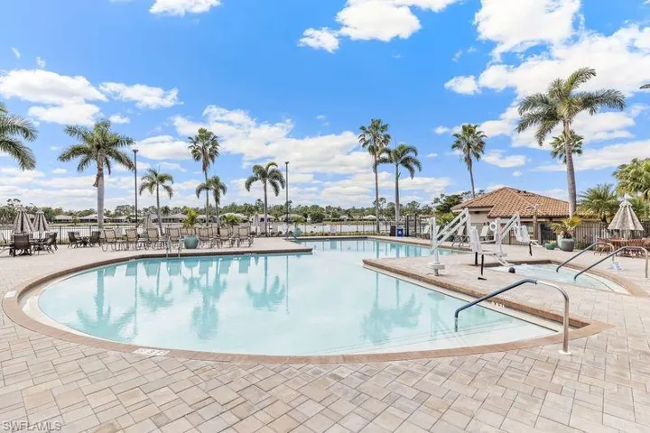 View of community swimming pool with a patio area