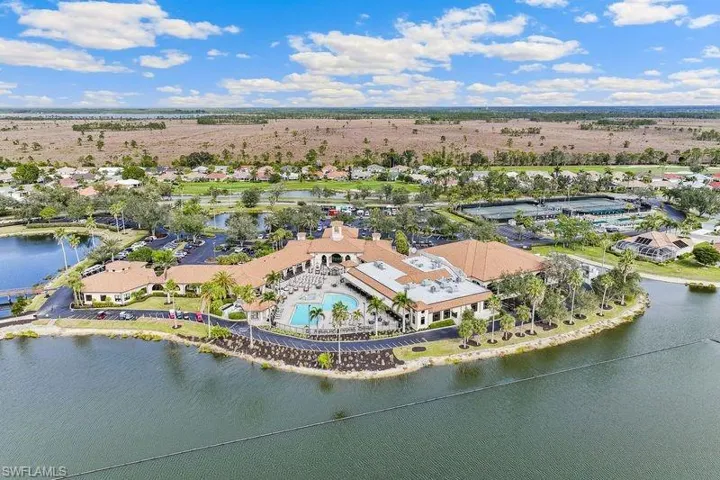 Drone / aerial view of the community clubhouse featuring a water view