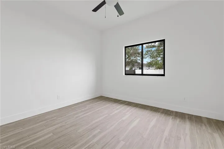 Unfurnished room featuring light wood-style floors and a ceiling fan