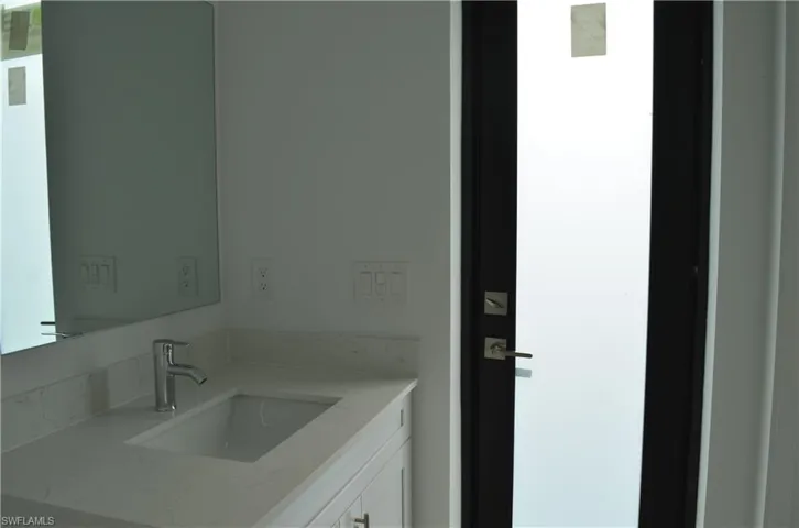 Half bathroom with backyard door