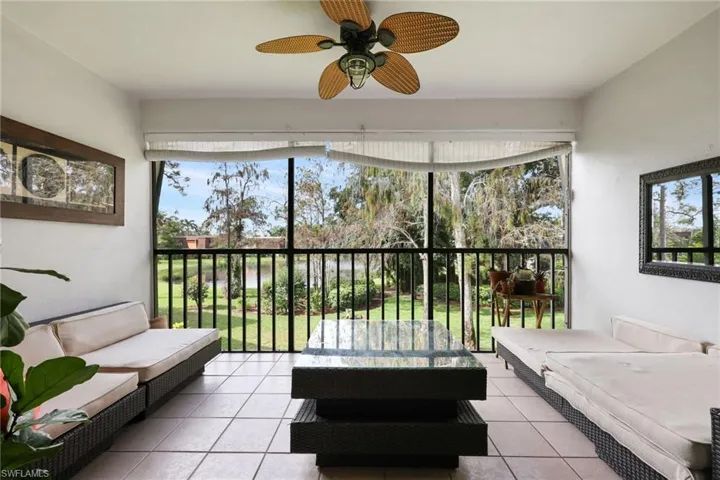 Sunroom featuring a ceiling fan