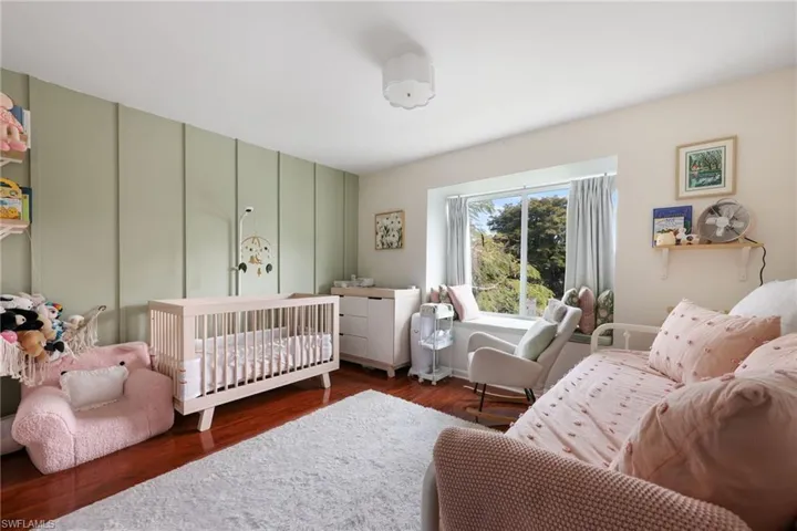 Bedroom with dark wood-type flooring