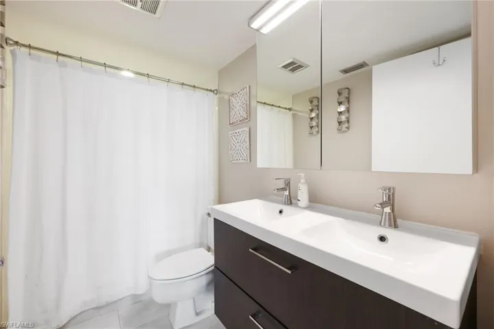Full bath with visible vents and a sink