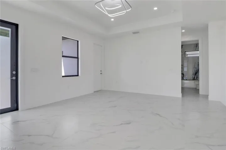 Spare room featuring a tray ceiling