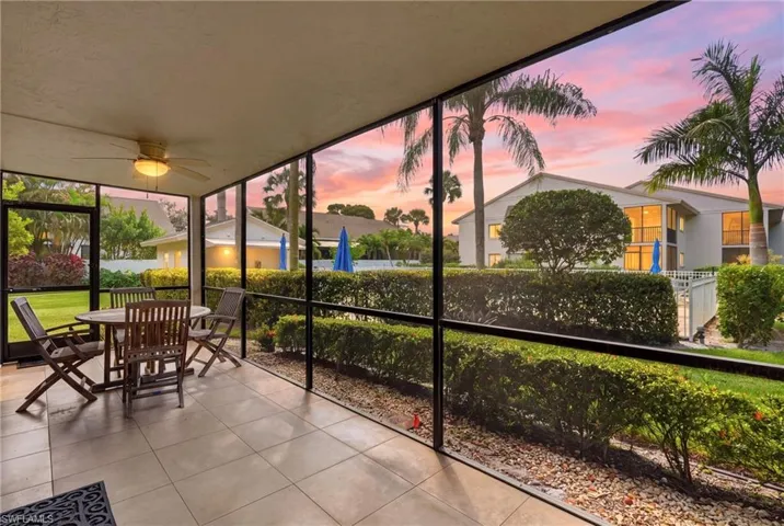 Screened-in porch featuring tiled flooring, a ceiling fan with integrated lighting, and metal framing