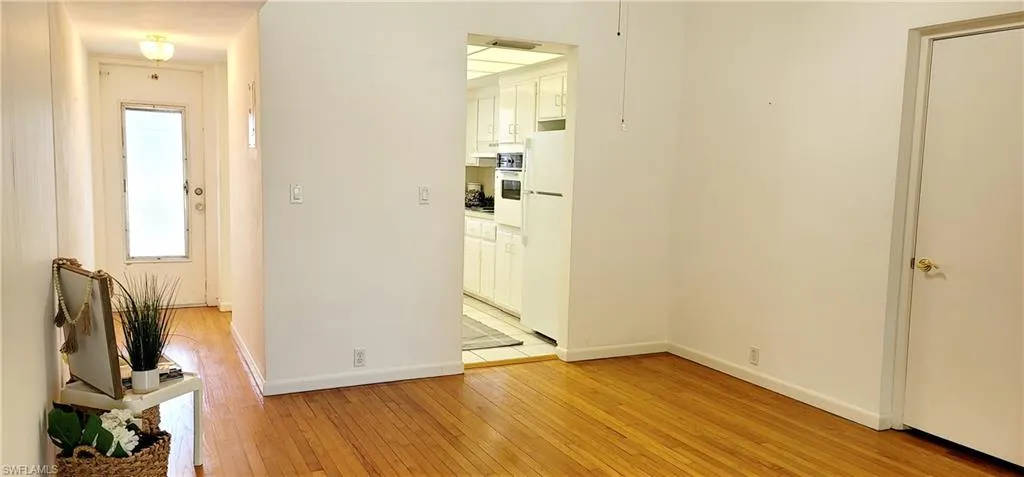 Hall with light hardwood / wood-style floors