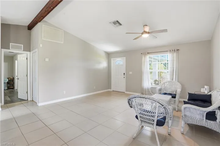 Sitting room with light tile patterned floors and ceiling fan