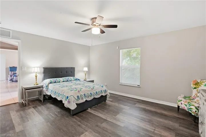 Bedroom with dark wood finished floors and ceiling fan