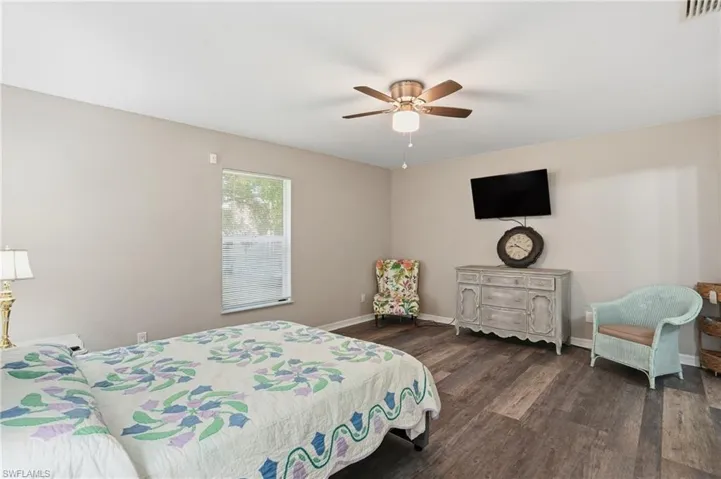 Bedroom with dark wood finished floors and ceiling fan