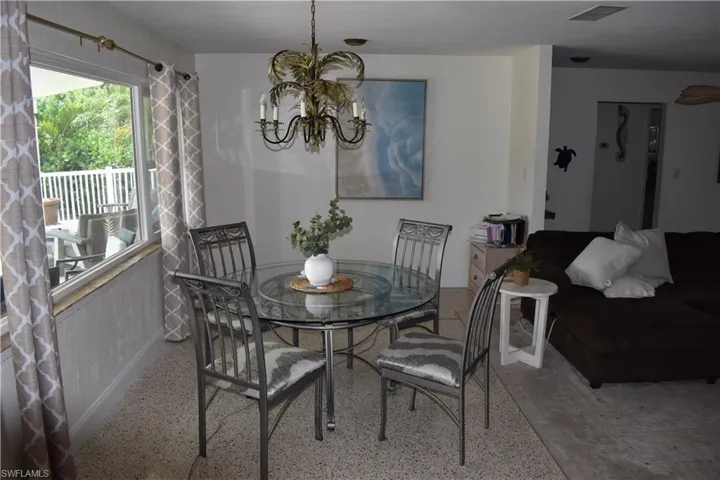 Dining area with water view behind property