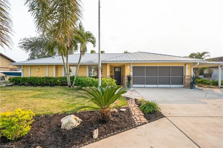 View of front of house with a front lawn and a garage
