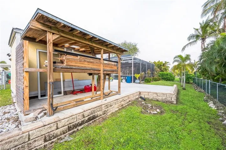 View of yard with a patio and glass enclosure