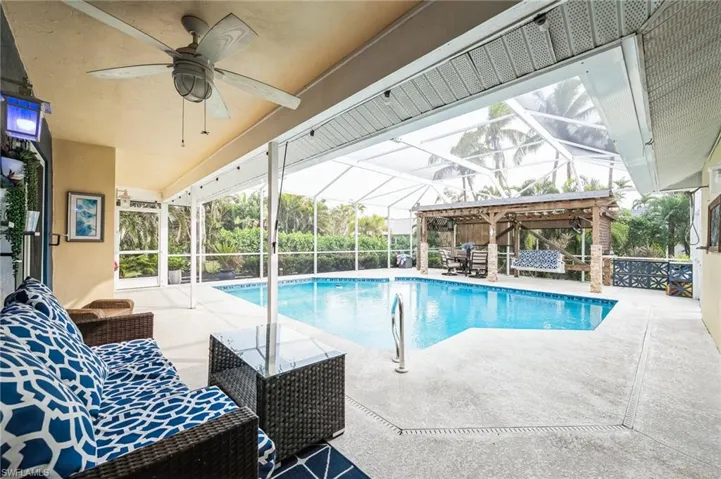 View of swimming pool featuring a lanai and a patio