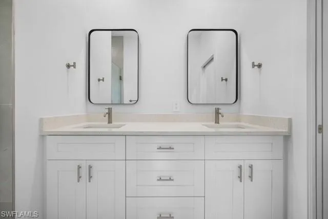 Master Bathroom featuring double vanity and a stall shower
