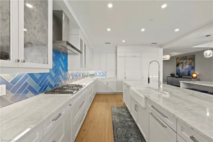 The large pantry is located to the right of the refrigerator door.