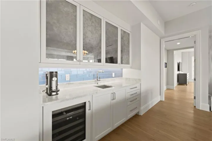 Wet bar is conveniently located alongside living area.