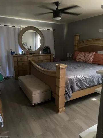 Bedroom with wood finished floors and ceiling fan