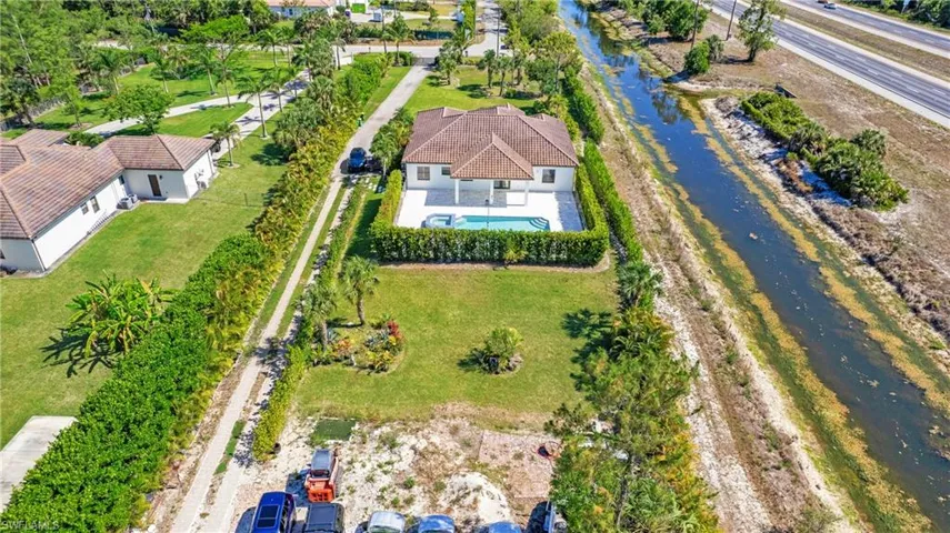 View from above of property with a pool area and a nearby body of water