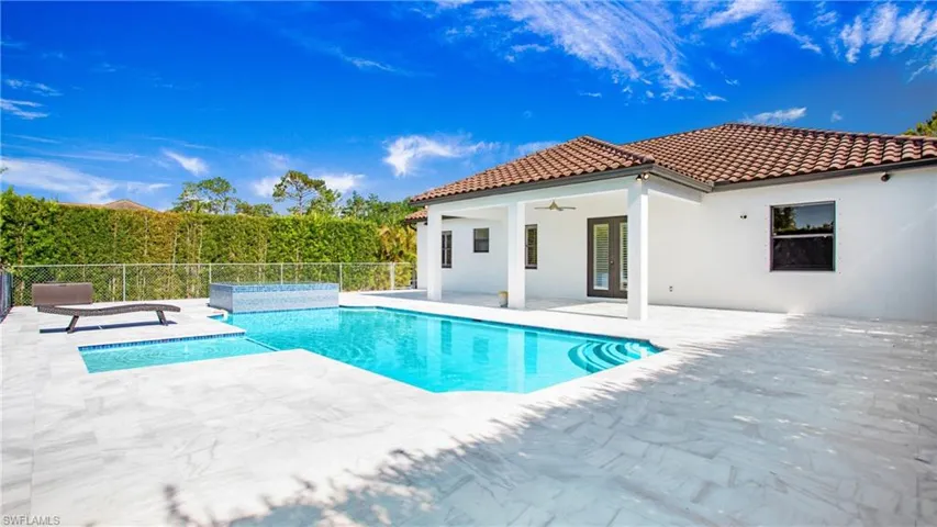 View of swimming pool featuring ceiling fan, a patio, and fence