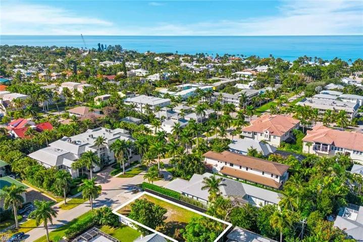 Aerial perspective of suburban area featuring a nearby body of water