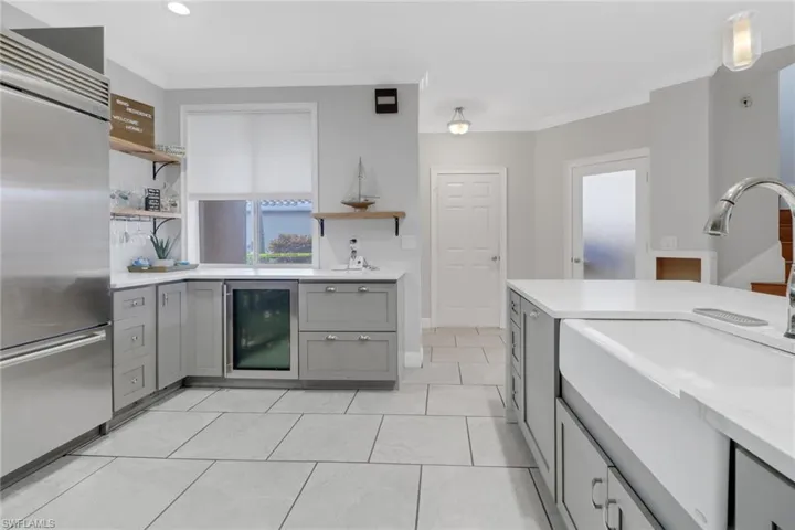 Large deep kitchen sink, and large storage drawers next to the wine cooler