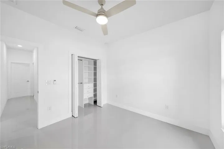 Unfurnished bedroom with tile patterned floors, a closet, and ceiling fan