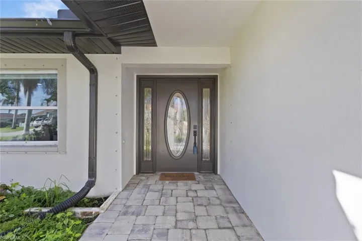 Entrance to property featuring stucco siding