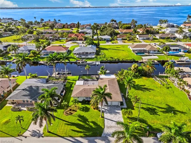 Aerial perspective of suburban area featuring a nearby body of water