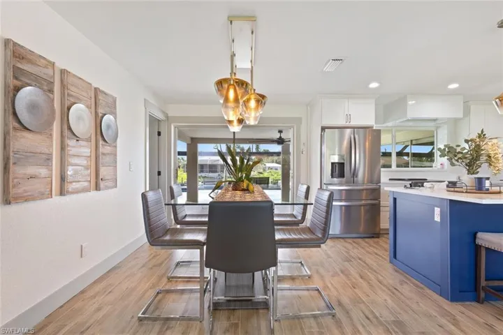 Dining room featuring plenty of natural light, light wood finished floors, and recessed lighting