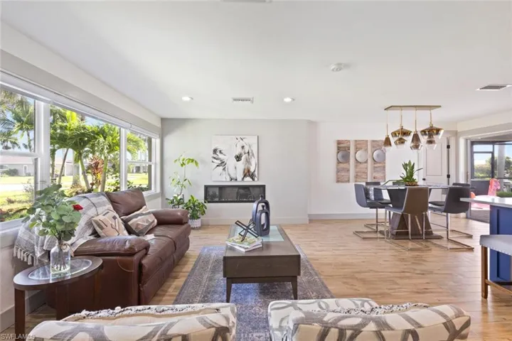 Living room with recessed lighting and light wood-style flooring