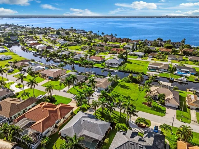 Aerial perspective of suburban area featuring a large body of water